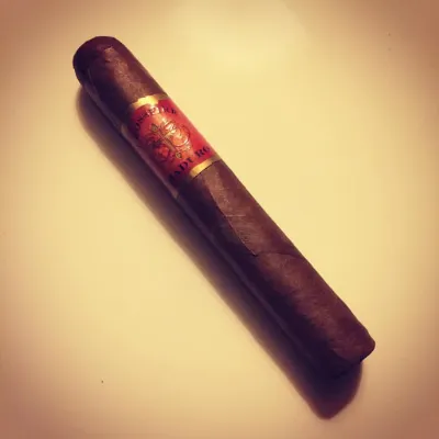 A Crossfire Maduro Gordo cigar on a warm-toned background