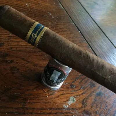A Mi Querida Ancho Largo cigar resting on a wooden table