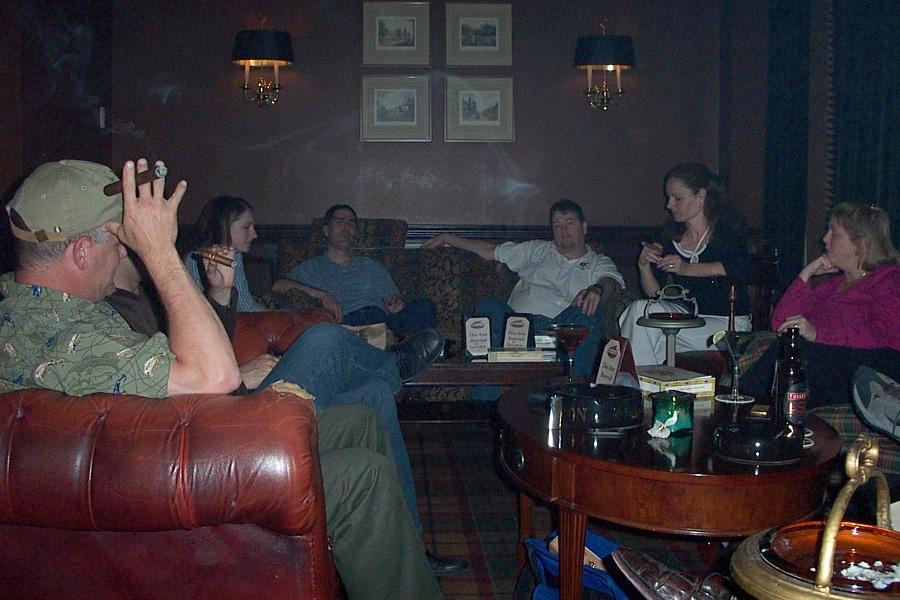 A typical herf: cigar smokers relaxing in leather armchairs around a low table in a wood-panelled lounge
