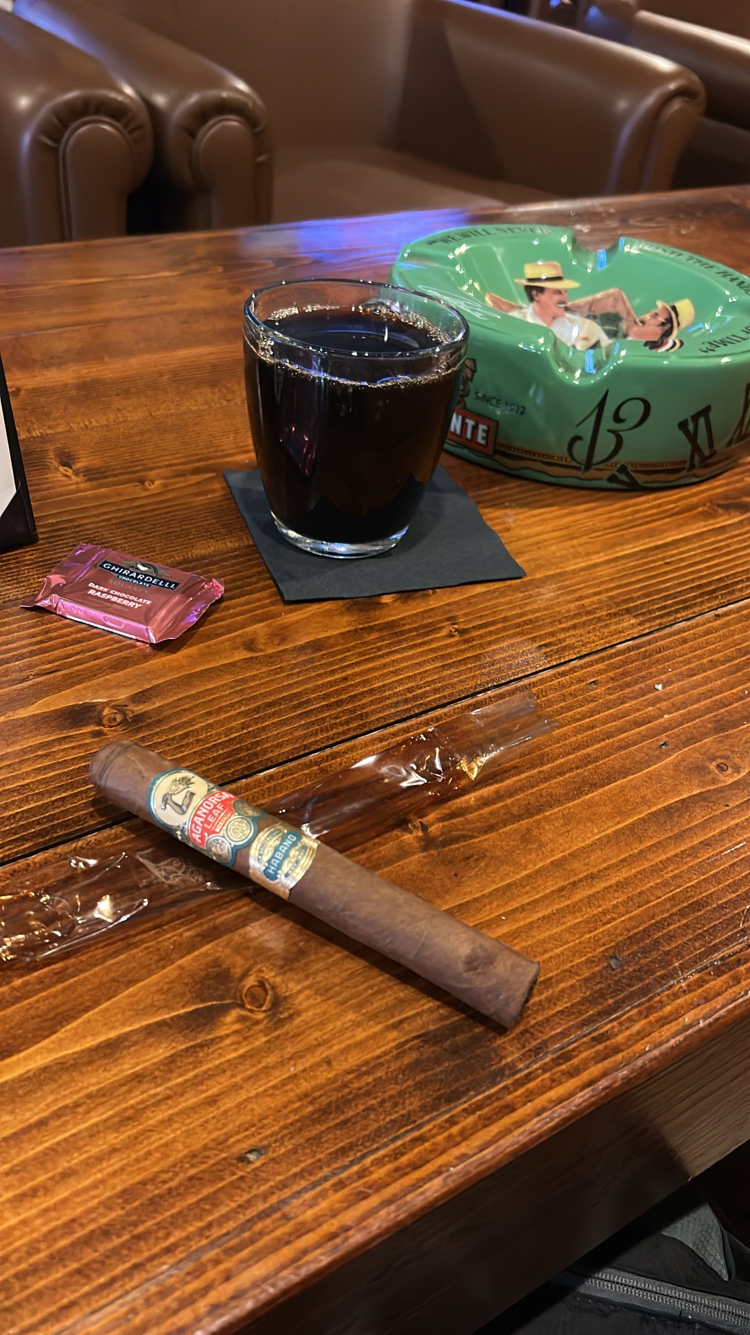An Aganorsa La Validacion cigar and a cup of black coffee on a wooden table at King Corona